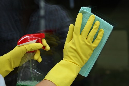 Professional domestic cleaner working in a Docklands apartment living area